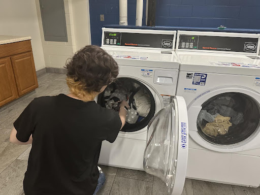 Resident completing laundry on campus.